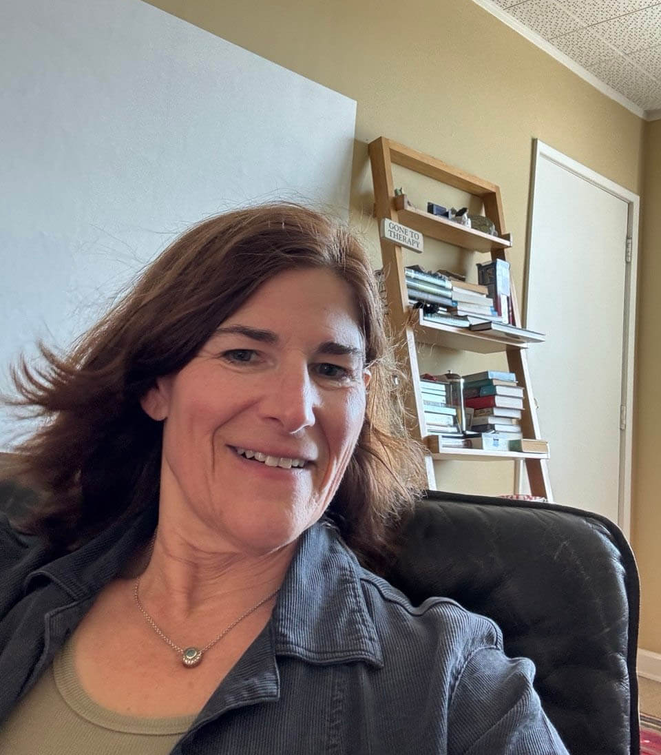 Dr. Leslie Snyder, PhD, smiling in a casual indoor portrait. | Leslie Synder, PhD